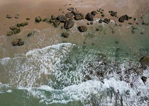 Waves and rocks along the shoreline seen from above