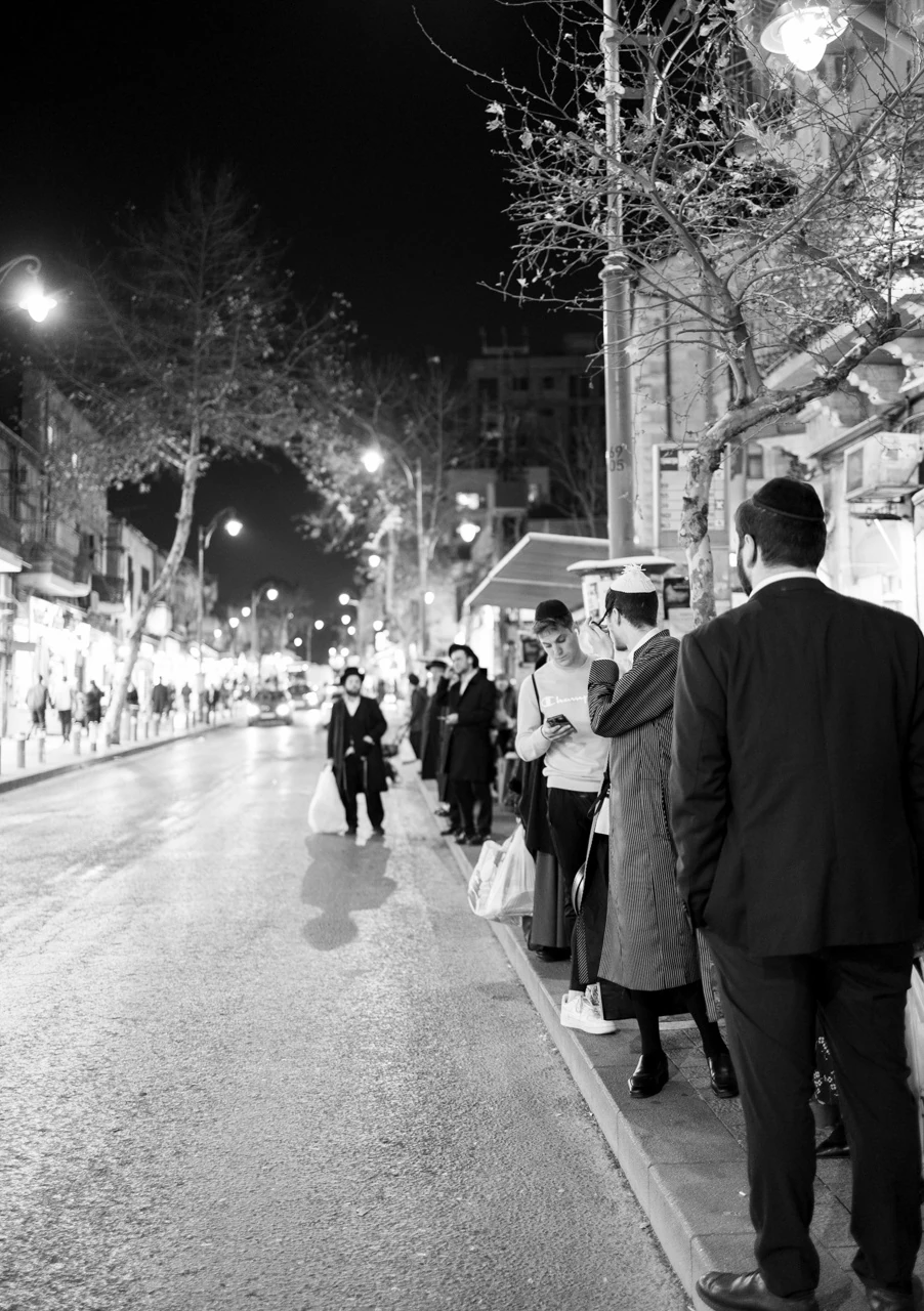 Pedestrians on a busy nighttime city street