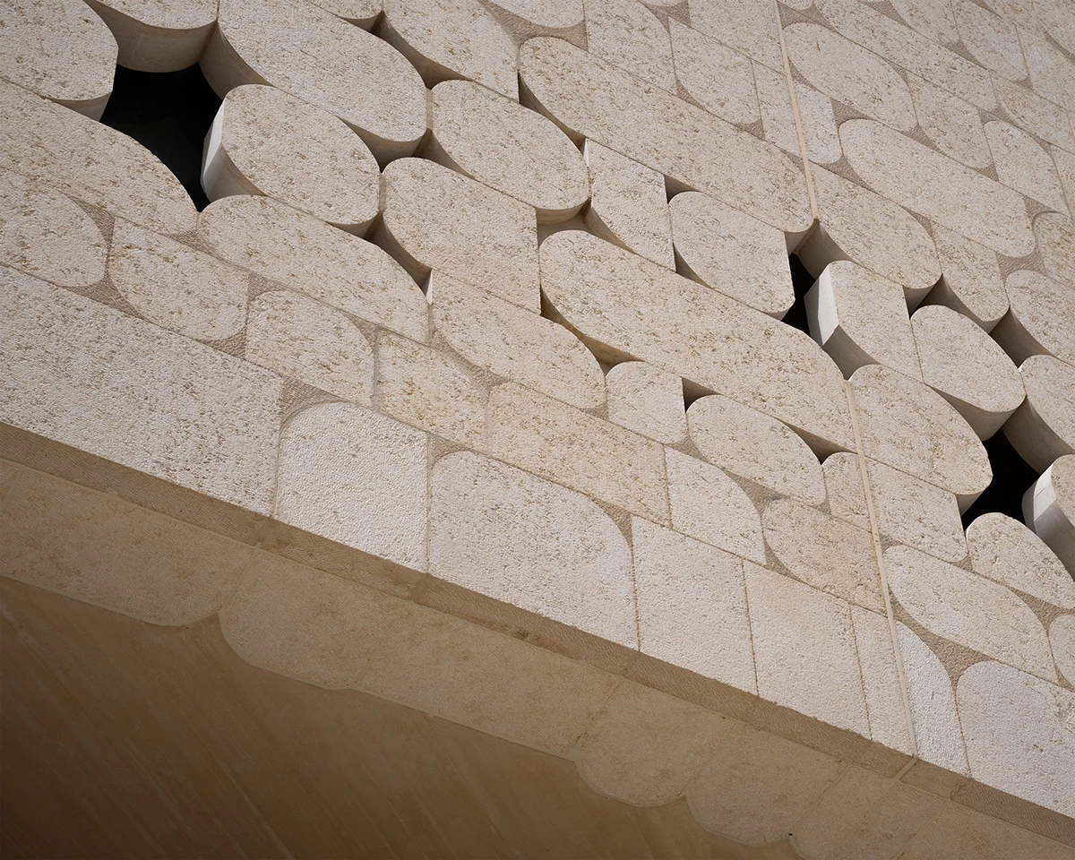 Close view of patterned limestone blocks on the library facade