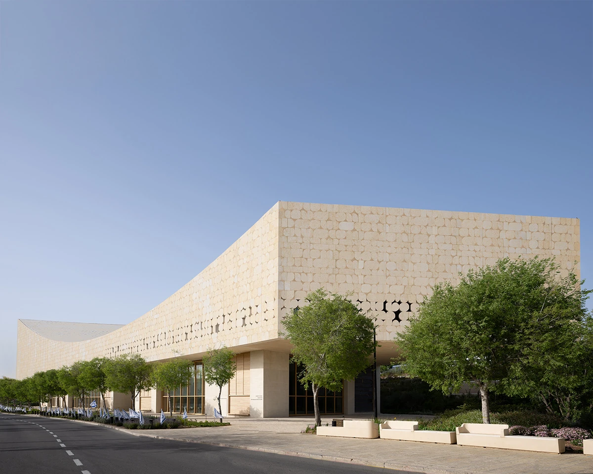 Library entrance and trees beside the stone exterior