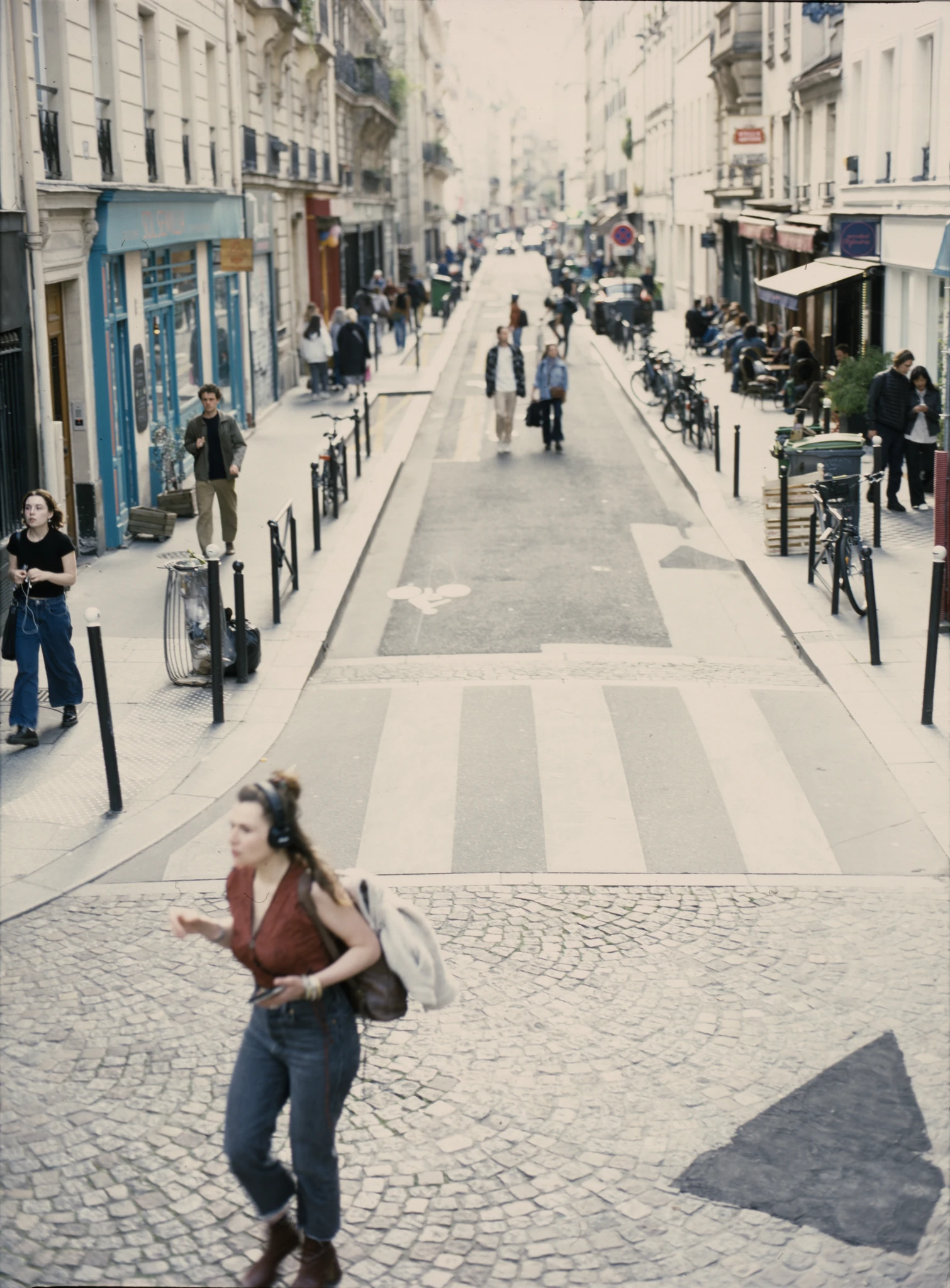 Pedestrians moving along a sloping shopping street