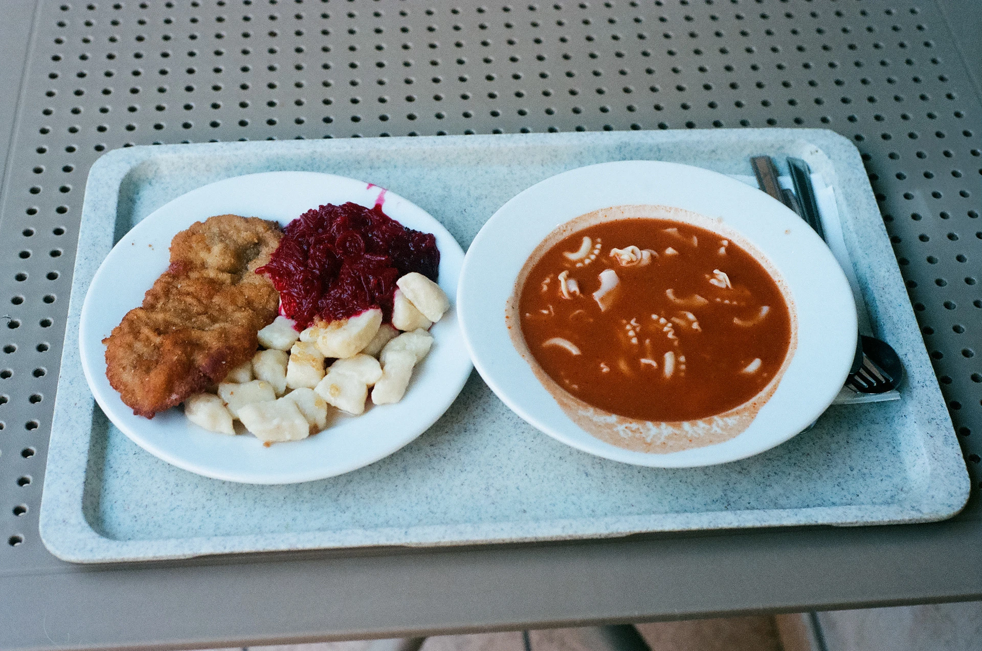 A tray with a bowl of soup and a plate of food